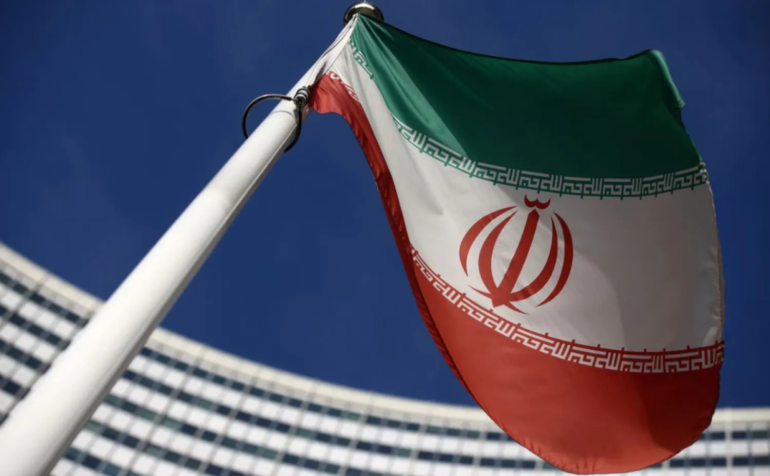 The Iranian flag waves in front of the International Atomic Energy Agency (IAEA) headquarters in Vienna, Austria, March 1, 2021. REUTERS/Lisi Niesner/File Photo