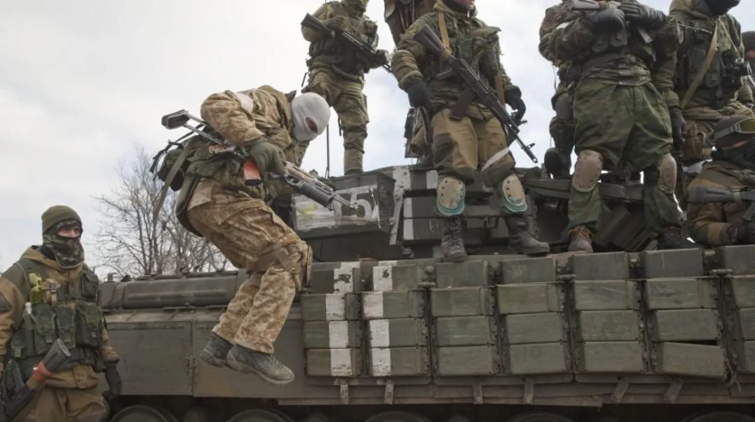 A Russia-backed rebel jumps off a tank in Debaltseve, Ukraine, Feb. 20, 2015. (AP Photo)
