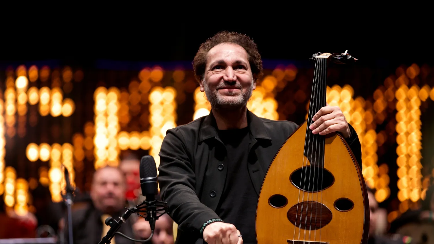 Iraqi virtuoso oud player Naseer Shamma prepares to perform with an orchestra, at the Iraqi National Theater in Baghdad, Iraq, Friday, Jan. 21, 2022. (AP Photo/Hadi Mizban)
