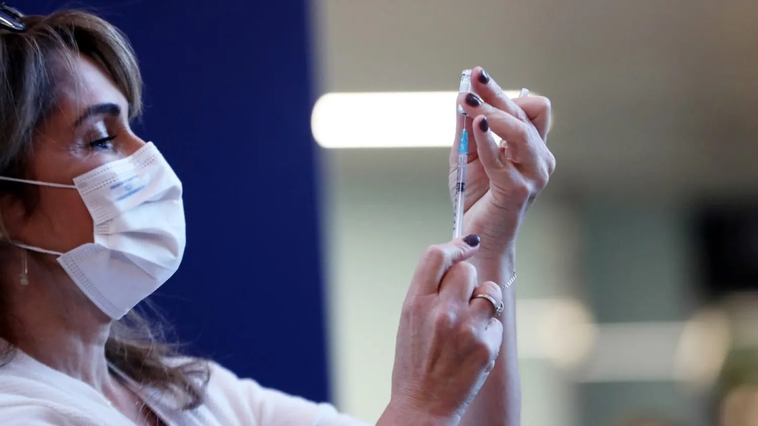 A medical worker prepares a coronavirus disease (COVID-19) vaccine as Israel kicks off a coronavirus vaccination drive, at Tel Aviv Sourasky Medical Center (Ichilov Hospital) in Tel Aviv, Israel December 20, 2020. - Reuters
