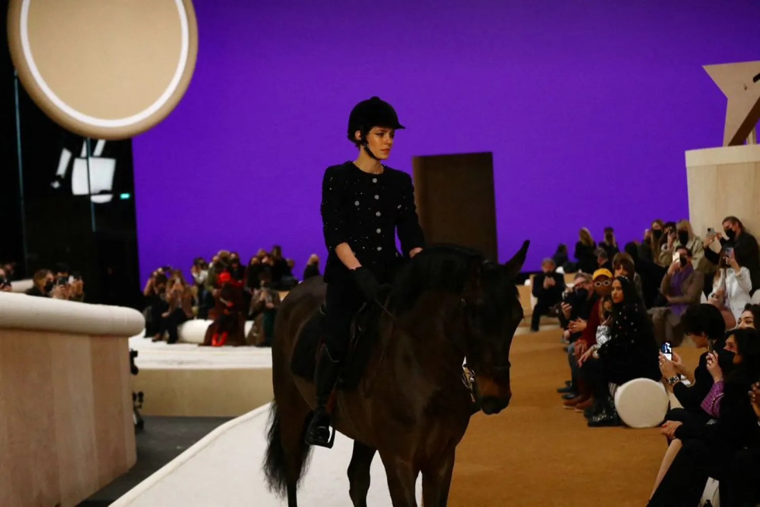 Charlotte Casiraghi appears on a horse at the end of her Haute Couture Spring/Summer 2022 collection show for fashion house Chanel in Paris, France, January 25, 2022. (Reuters)