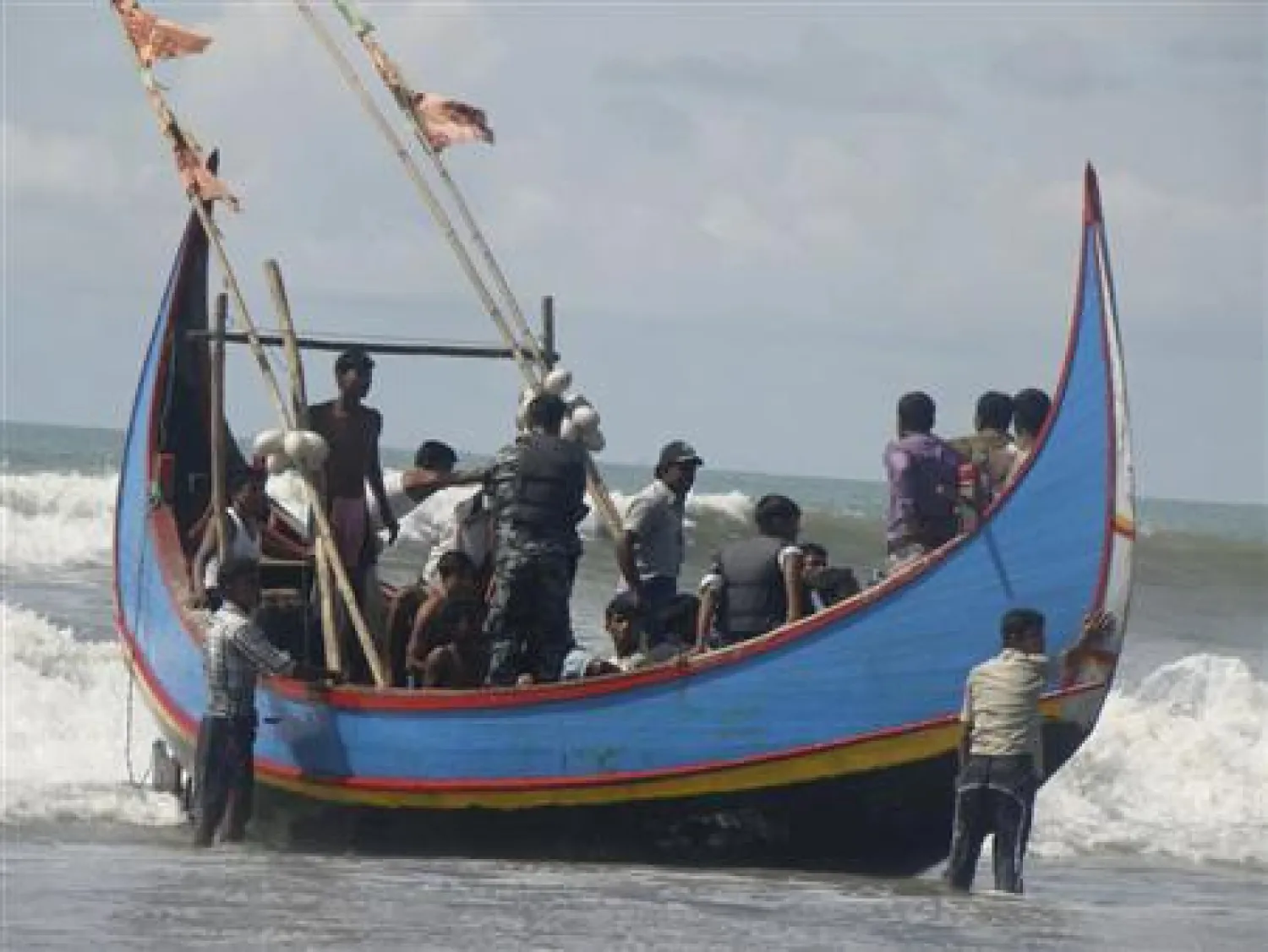 Members of Bangladesh Navy are seen with people rescued from a sunken boat in Bay of Bengal in Teknaf November 7, 2012. FILE/REUTERS/Stringer
