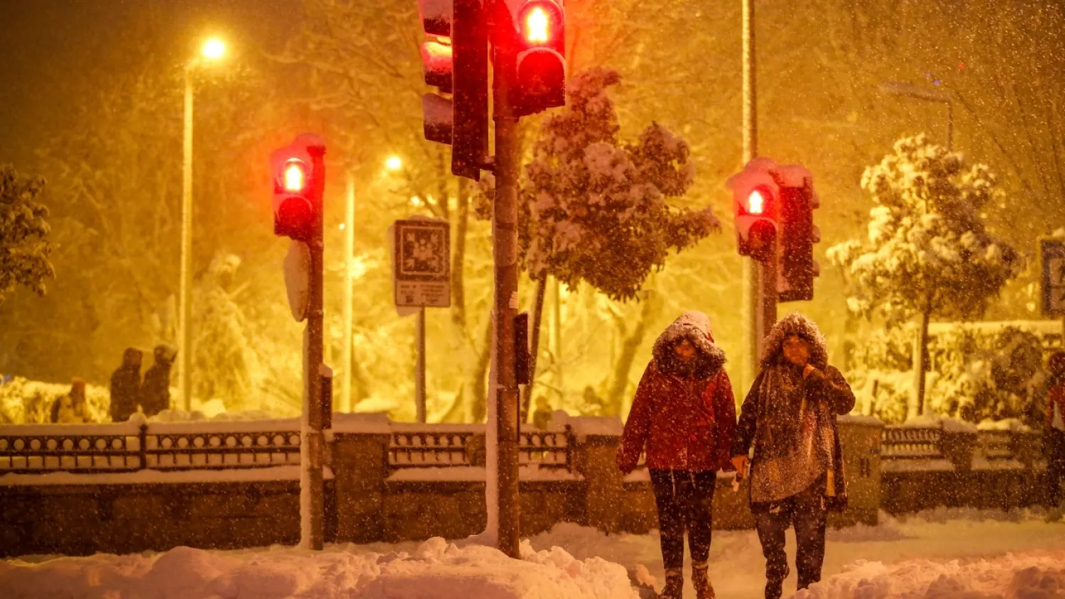 Pedestrians walk during snow fall in Istanbul, Turkey, on Monday, Jan. 24, 2022. (AP)