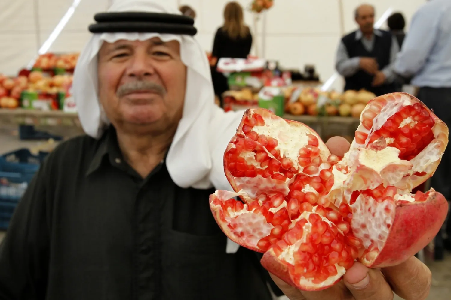 File photo, man holding a pomegranate. Reuters