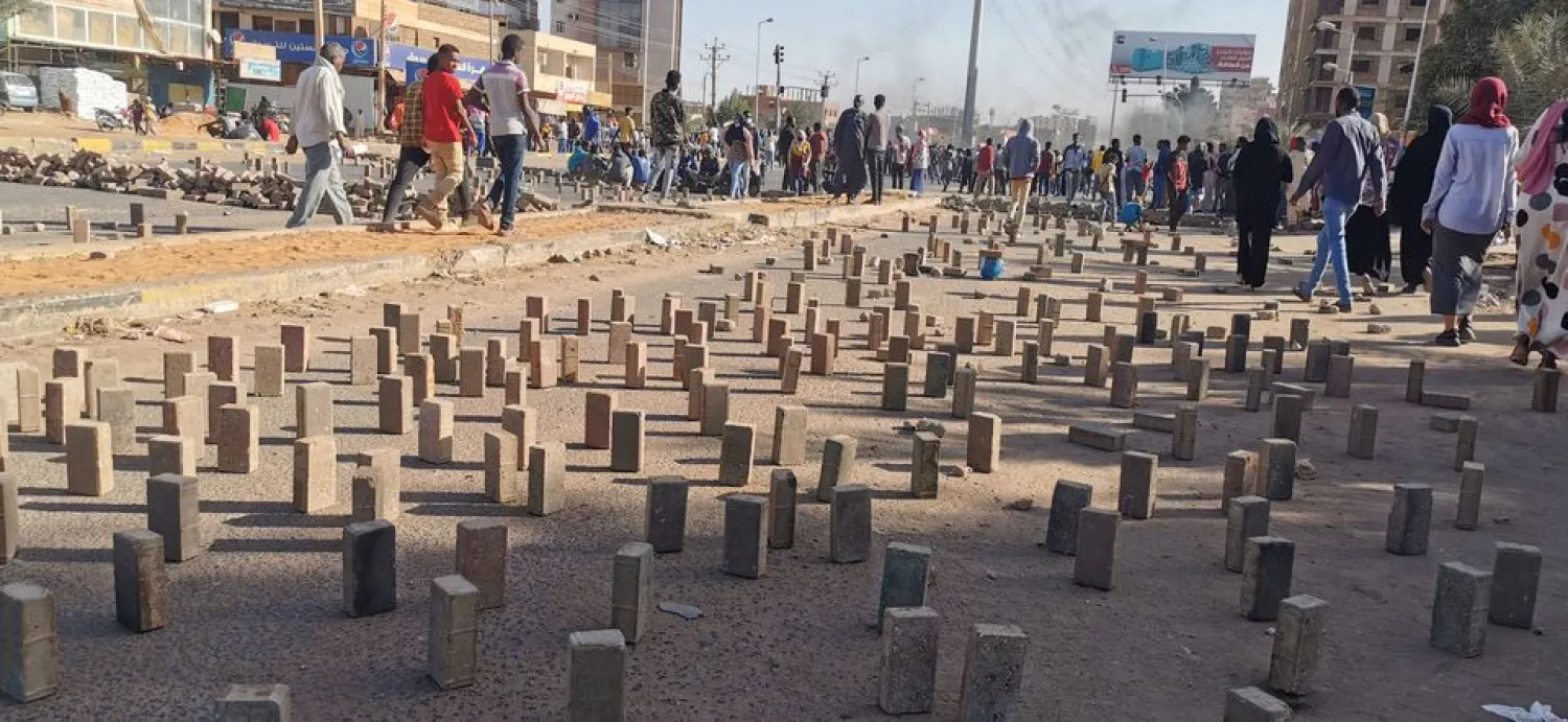 Pavement tiles lie on the street as demonstrators attend a protest in Khartoum, Sudan, January 20, 2022. (Reuters)
