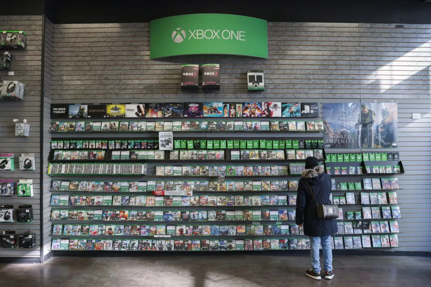 A person browses games at an XBox One Display in a GameStop in Manhattan, New York, US, December 7, 2021. (Reuters)