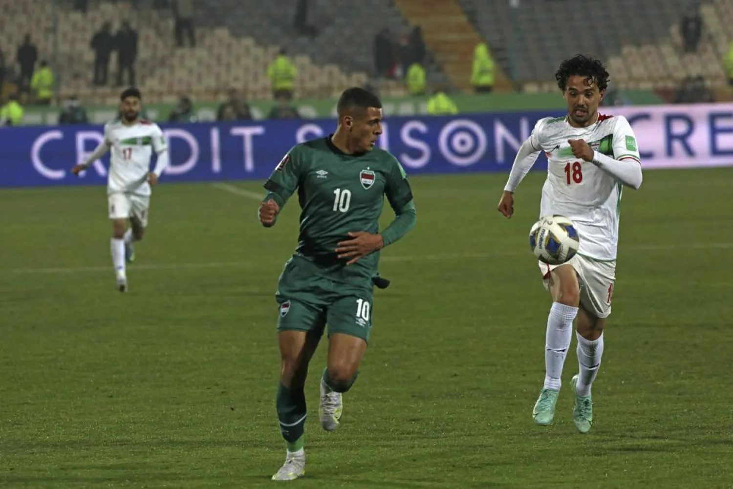 Iran's Omid Nor Afkan, right, and Iraq's Ali Ibrahim Alzubaidi run for the ball during their 2022 World Cup qualifier soccer match, at the Azadi stadium in Tehran, Iran, Thursday, Jan. 27, 2022. Iran became the first team from Asia to qualify for this year's World Cup in Qatar with a 1-0 win over Iraq. (AP Photo/Vahid Salemi)
