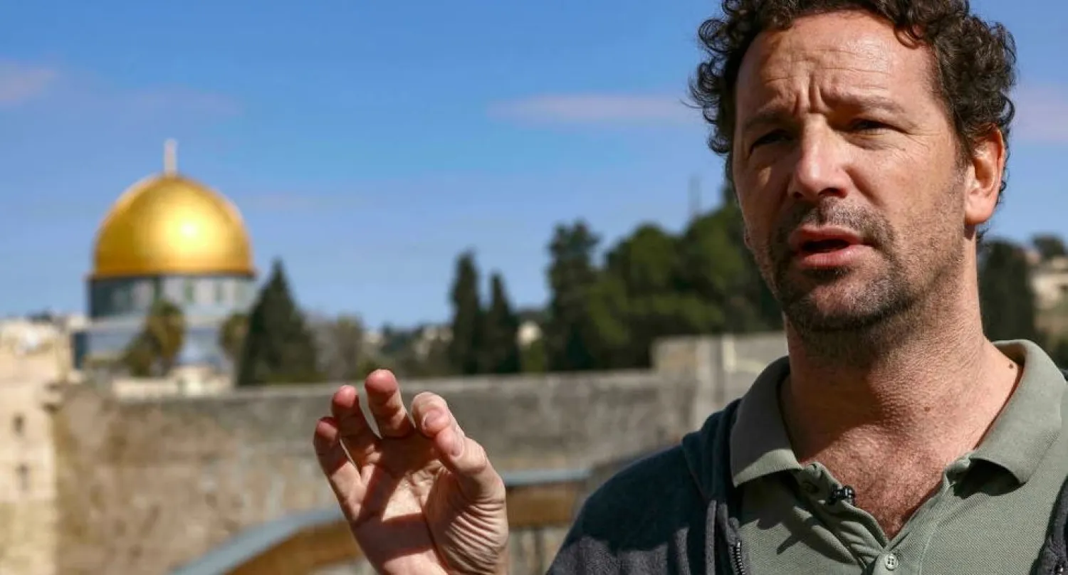 French historian Vincent Lemire speaks during a interview near the Western Wall in Jerusalem with the Dome of the Rock in the background RONALDO SCHEMIDT AFP