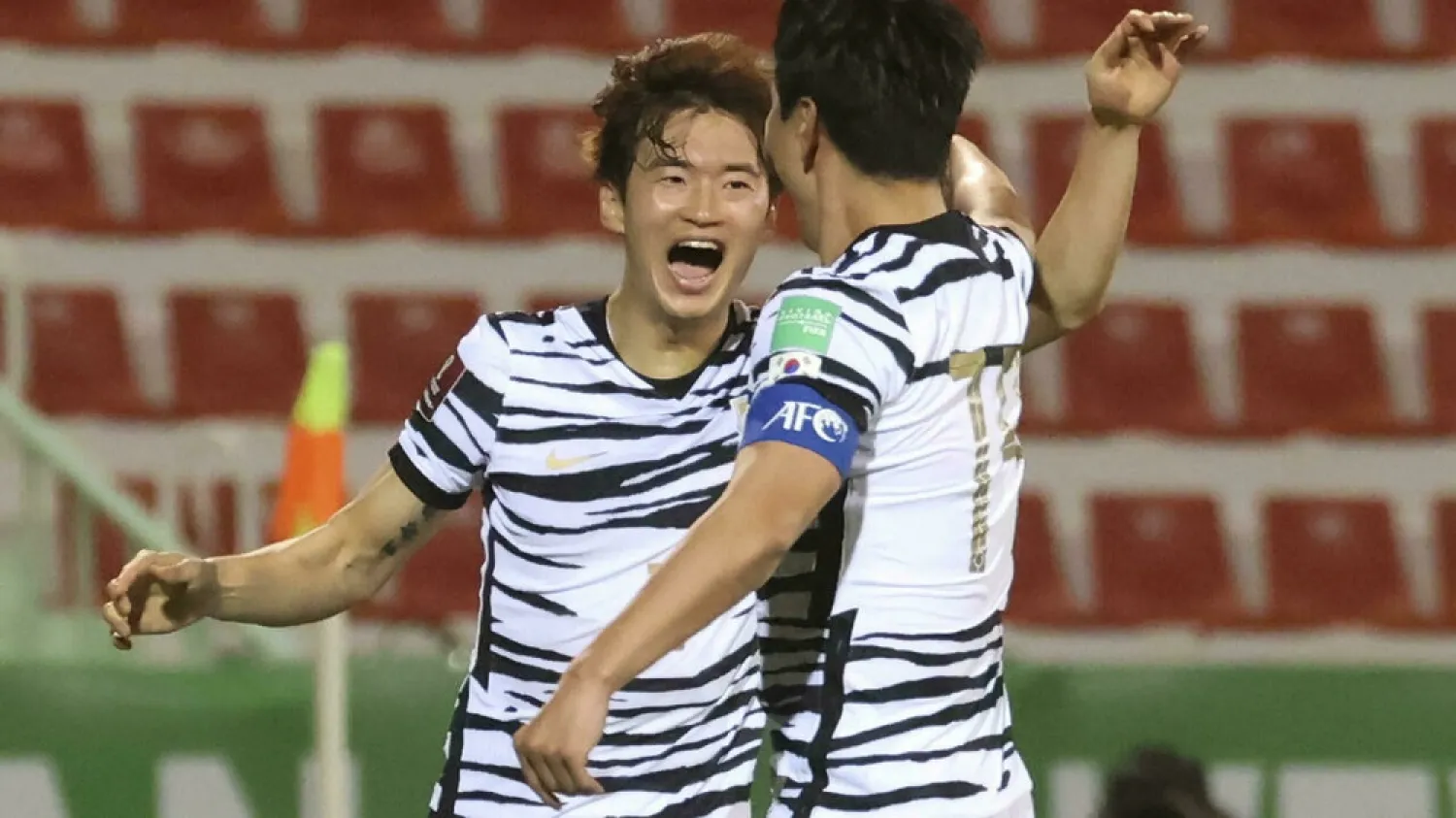  Kim Jin-su (left) accepts congratulations after scoring South Korea's opener against Syria. (AFP)