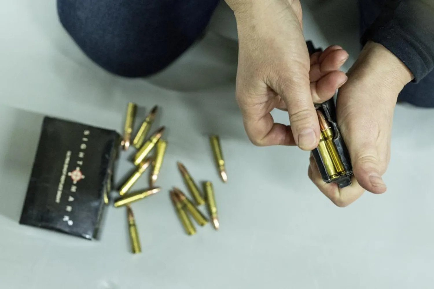 A woman loads ammunition for a Kalashnikov assault rifle during training in Kharkiv, Ukraine, Sunday, Jan. 30, 2022. (AP)