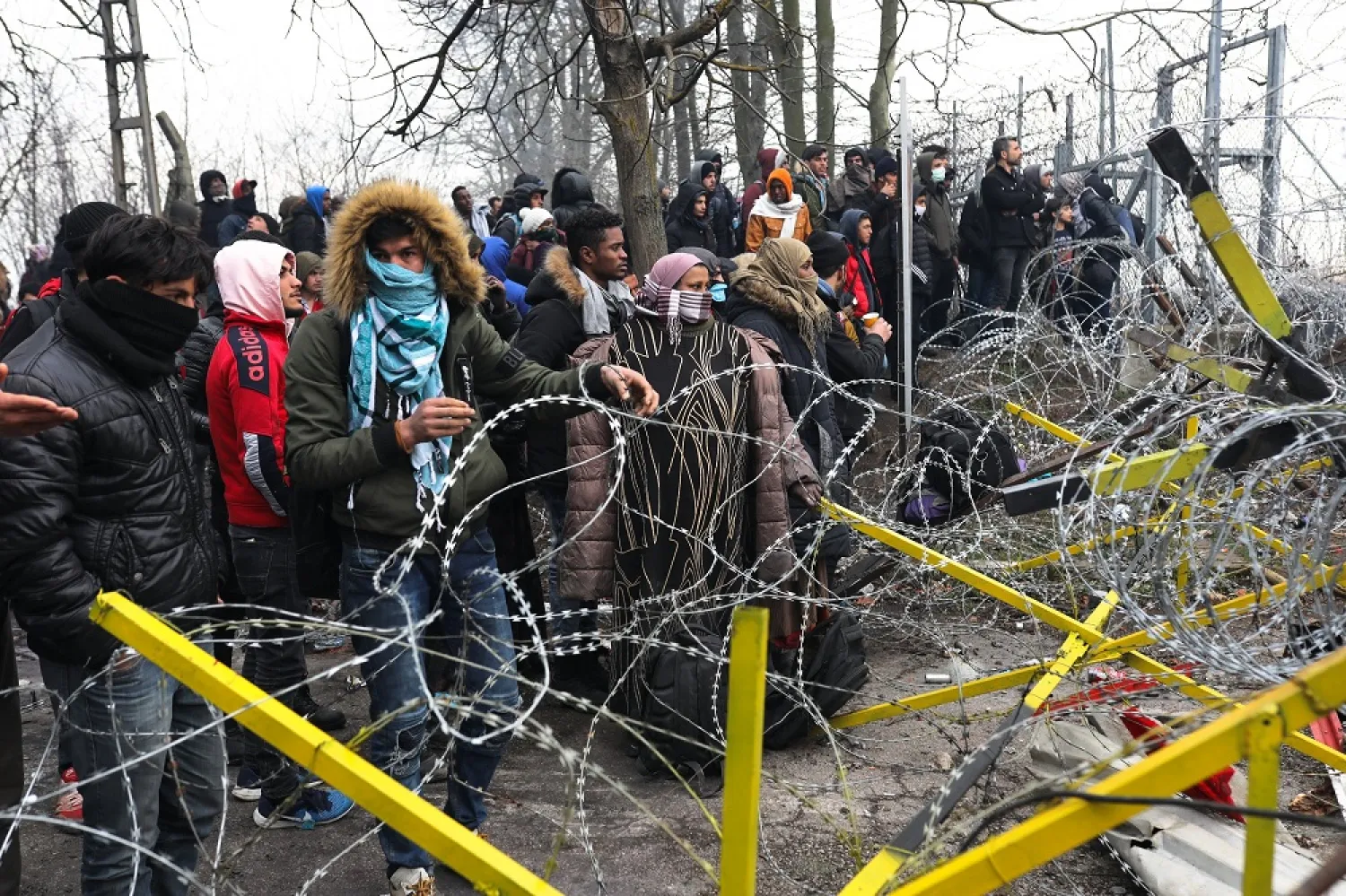 Migrants trying to communicate with Greek soldiers at the Turkish-Greek border, at Pazarkule Border Crossing in Edirne, Turkey, Feb. 29, 2020. (Getty Images)