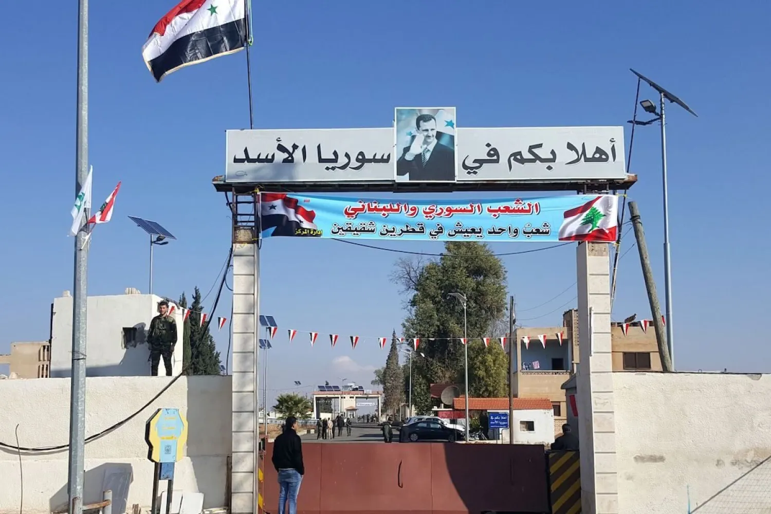 A picture taken on December 14, 2017 shows a general view of people standing at the Al-Qaa border crossing in Lebanon and Jussiyeh in Syria. [STRINGER/AFP via Getty Images]