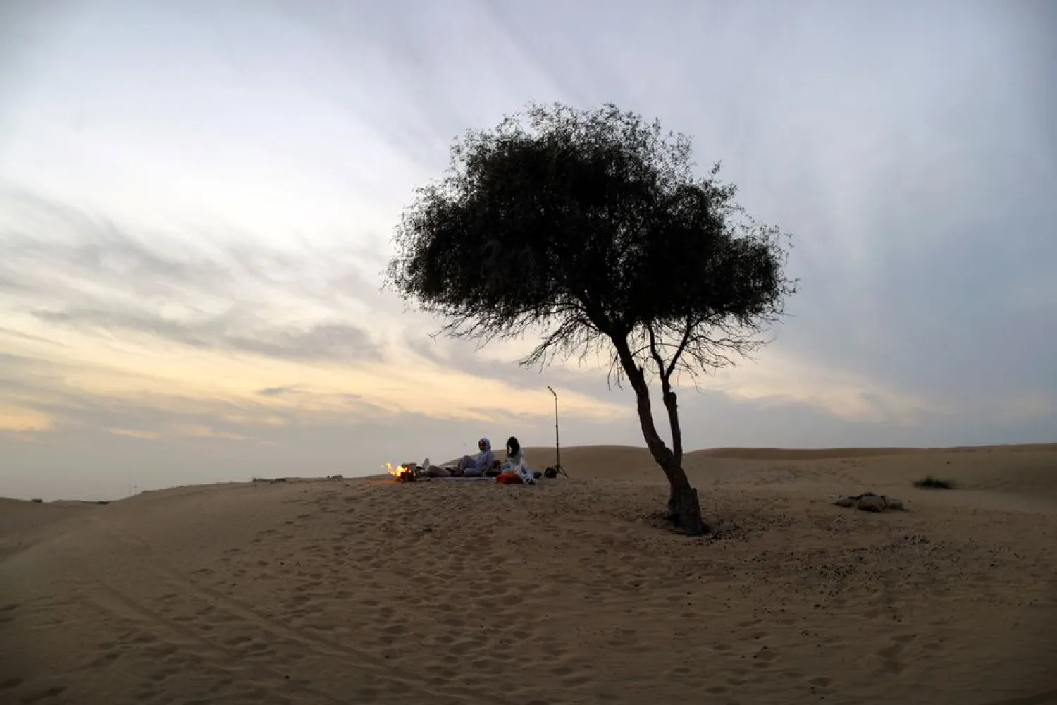 People spend time at the desert, amid the spread of the coronavirus disease (COVID-19) in Dubai, United Arab Emirates, February 18, 2021. (Reuters)