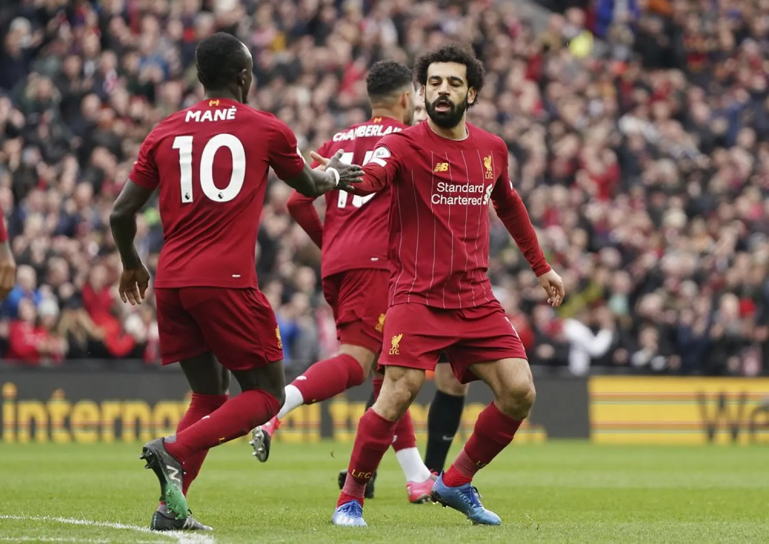 FILE: Liverpool's Mohamed Salah, right, celebrates with his teammate Sadio Mane after scoring his side's opening goal during the English Premier League soccer match between Liverpool and Bournemouth at Anfield stadium in Liverpool, England, Saturday, March 7, 2020. (AP Photo/Jon Super)
