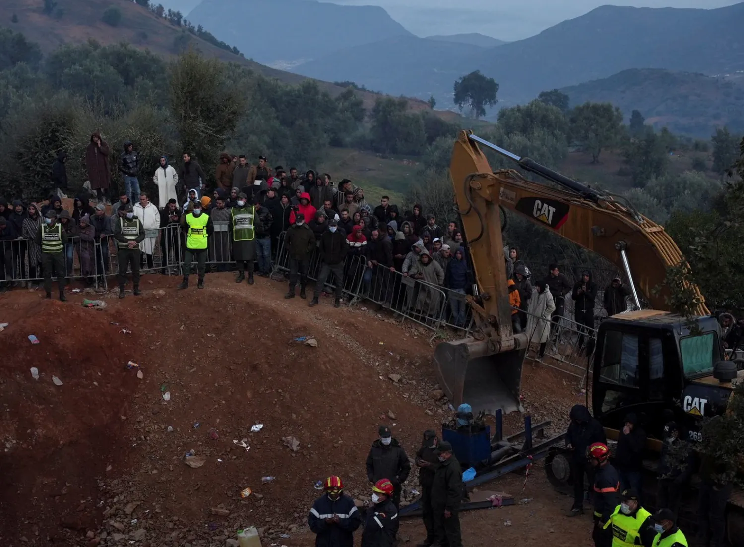 People gather as rescuers work to reach a five-year old boy trapped in a well in the northern hill town of Chefchaouen, Morocco February 5, 2022. REUTERS/Thami Nouas