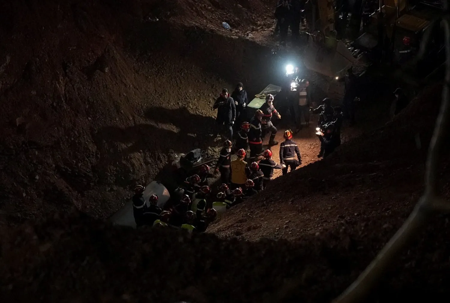 Rescue workers carry 5-year-old child, Rayan Awram, who has been trapped for five days in a well, to an ambulance, during a rescue operation near Chefchaouen