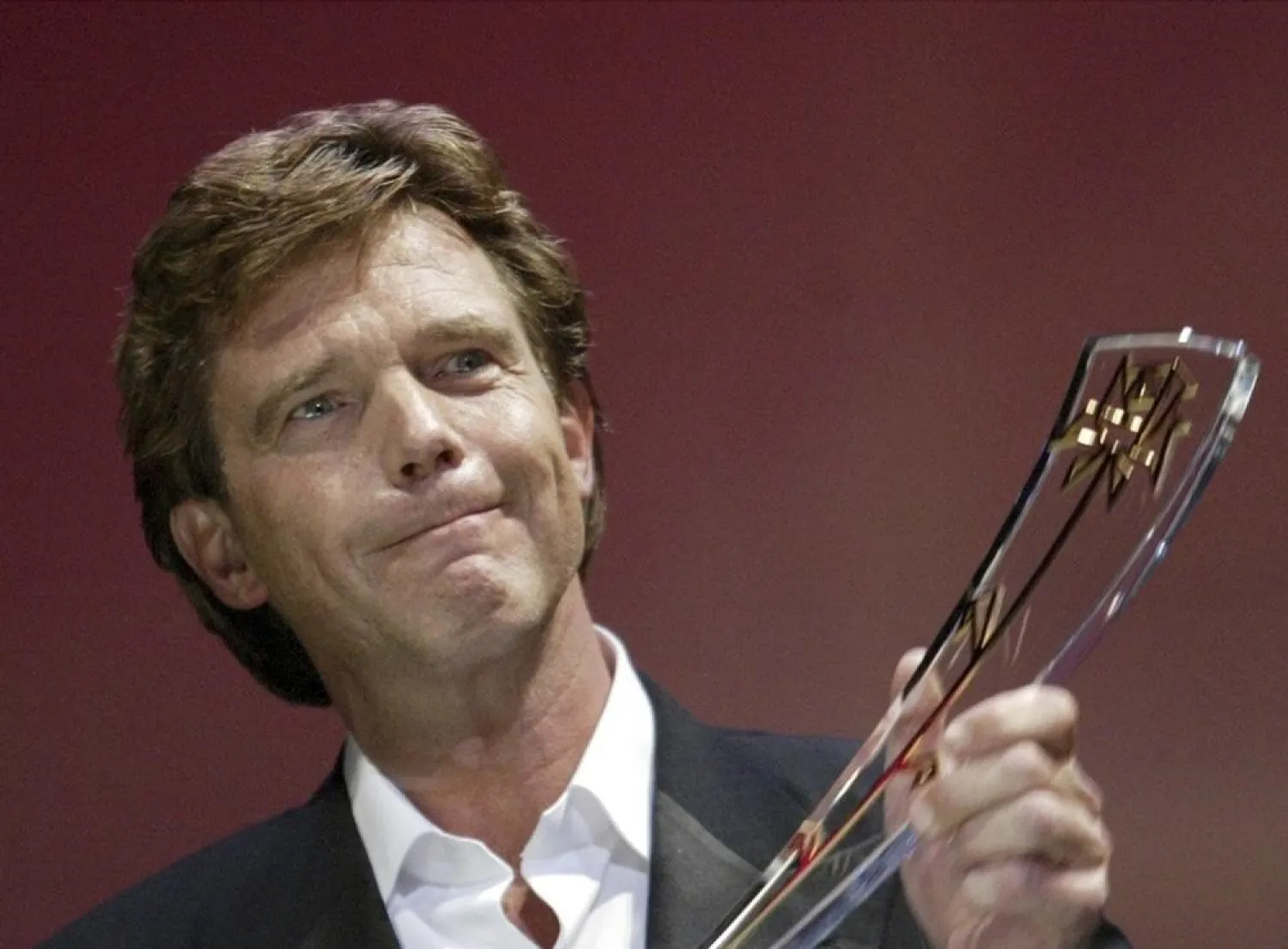 John de Mol from the Netherlands receives the Golden Rose Award 2004 in the category Honorary Golden Rose 2004 during the official award ceremony of the 44th Rose d'Or festival at the Culture and Congress Center (KKL) in Lucerne, Switzerland, Saturday, April 17, 2004. (AP)