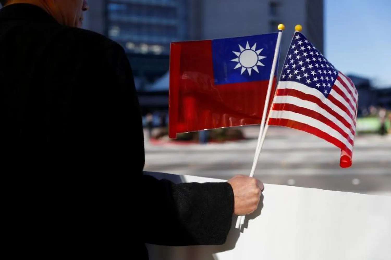 FILE PHOTO - A demonstrator holds flags of Taiwan and the United States in support of Taiwanese President Tsai Ing-wen during a stop-over after her visit to Latin America in Burlingame, California, US, January 14, 2017. REUTERS/Stephen Lam

