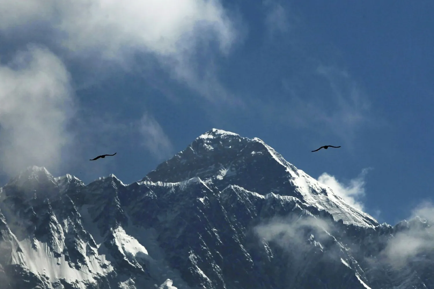 Birds fly as Mount Everest is seen from Namche Bajar, Solukhumbu district, Nepal, May 27, 2019. (AP Photo)