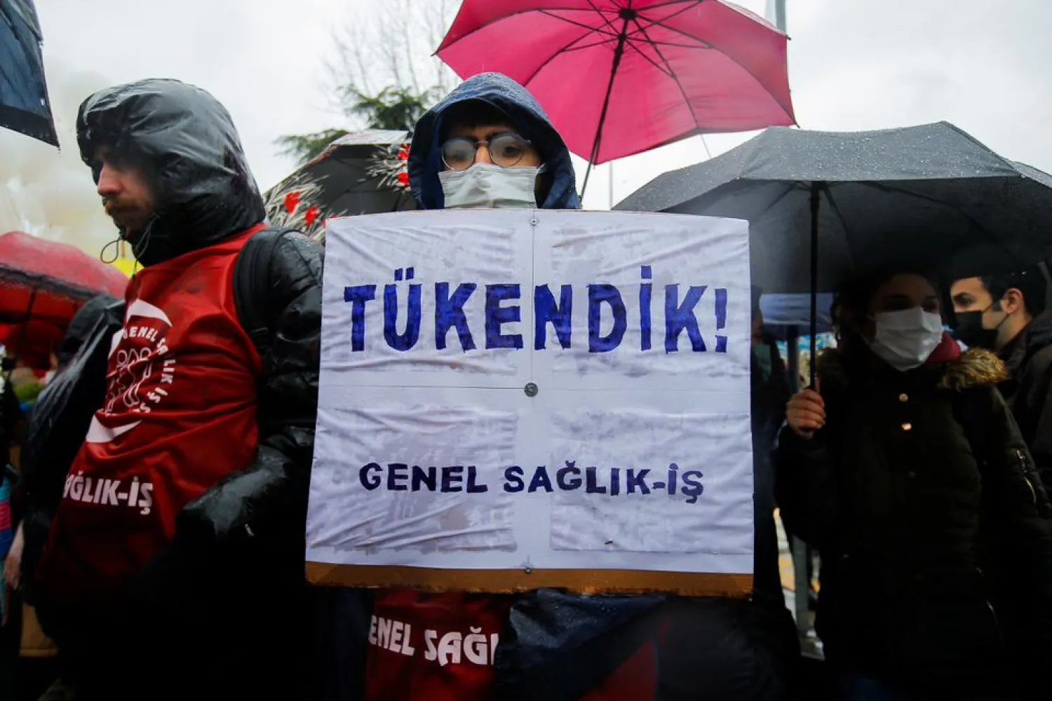 Medical workers take part in a protest against poor wages and harsh working conditions, in Diyarbakir, Turkey, February 8, 2022. The placard reads, "We are burned out!". (Reuters)