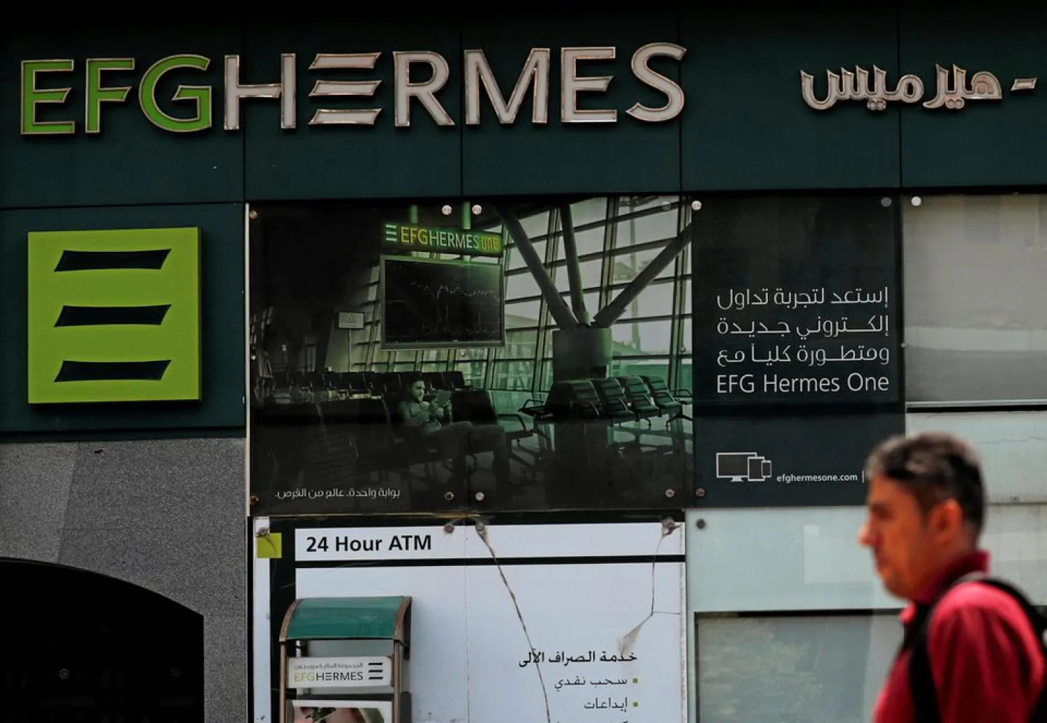 An Egyptian man walks past a branch of the EFG Hermes investment bank in Cairo, Egypt May 29, 2018. REUTERS/Amr Abdallah Dalsh

