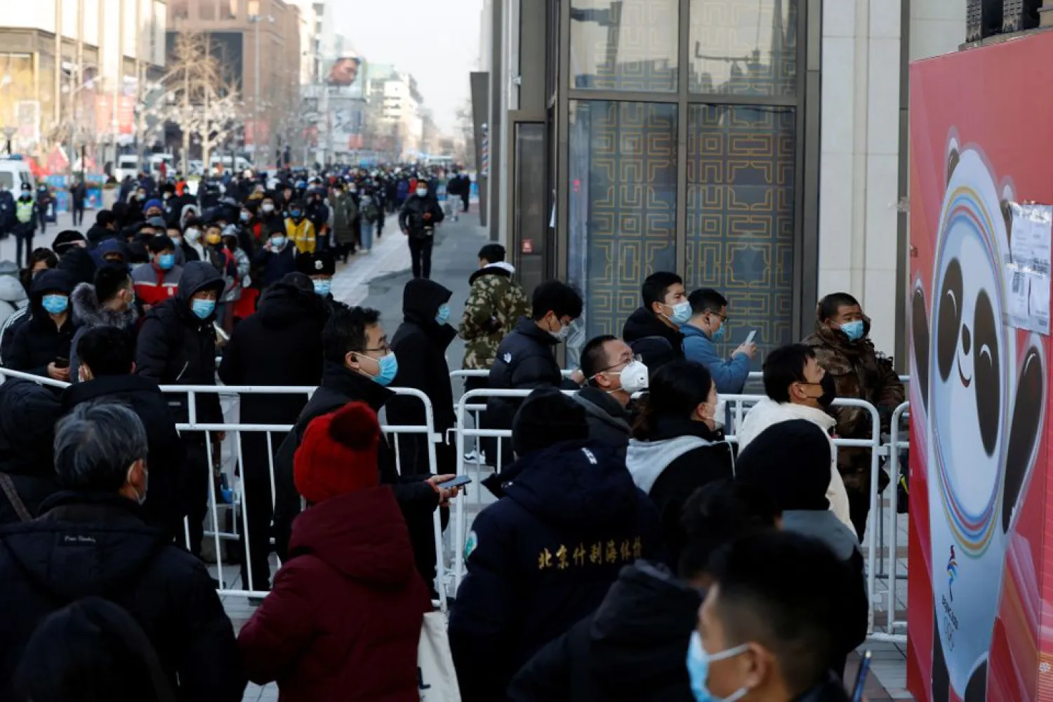 People wearing face masks, after the coronavirus disease (COVID-19) outbreak, wait in line to enter a flagship merchandise store for the Beijing 2022 Winter Olympics on Wangfujing street in Beijing, China February 9, 2022, following a surge in demand for merchandise featuring the official mascot Bing Dwen Dwen. (Reuters)