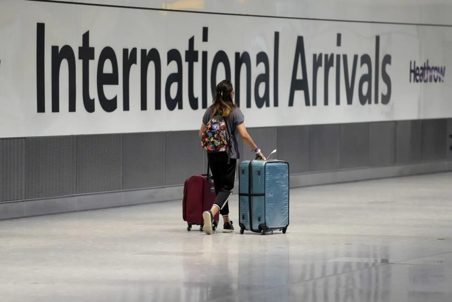 A passenger arrives from a flight at Terminal 5 of Heathrow Airport in London, Monday, Aug. 2, 2021. (AP)