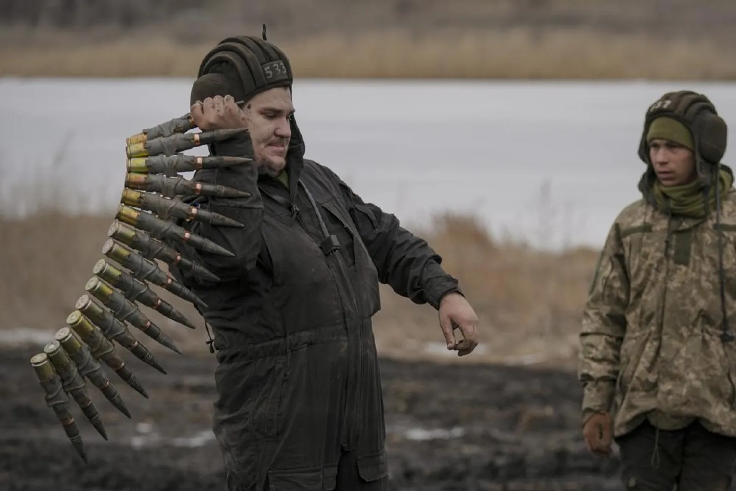 A Ukrainian serviceman handles large caliber ammunitions for armored fighting vehicles mounted weapons during an exercise in a Joint Forces Operation controlled area in the Donetsk region, eastern Ukraine, Thursday, Feb. 10, 2022. (AP)