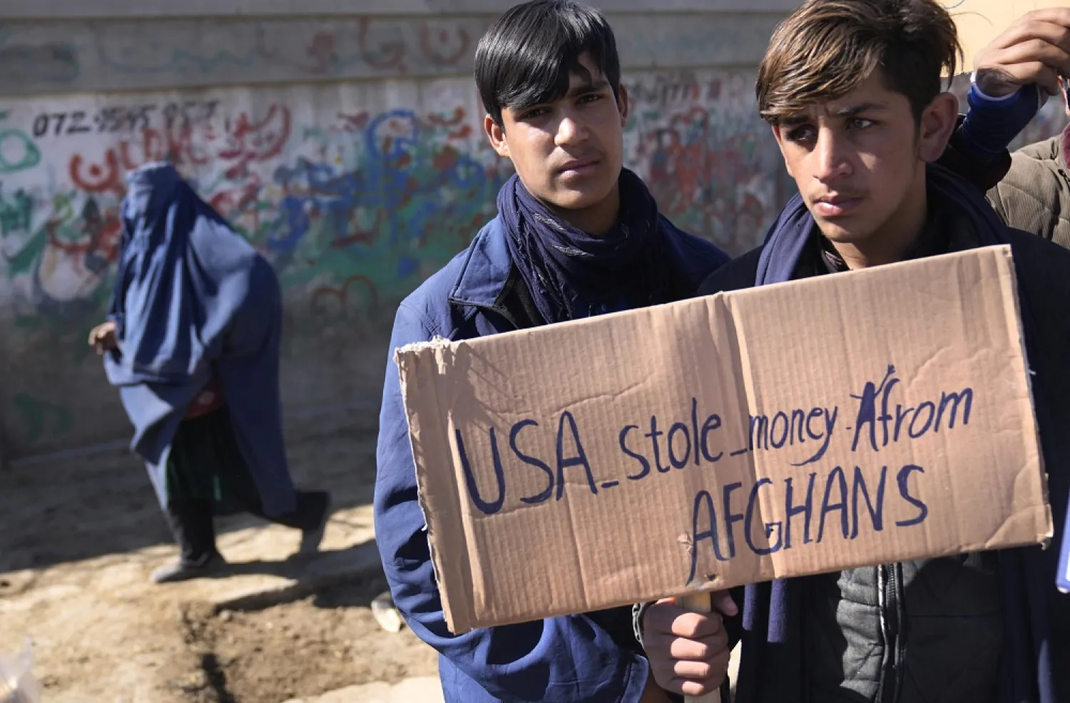 Afghan protesters hold placards and shout slogans against US during a protest condemning President Joe Biden’s decision, in Kabul, Afghanistan, Saturday, Feb. 12, 2022. (AP)