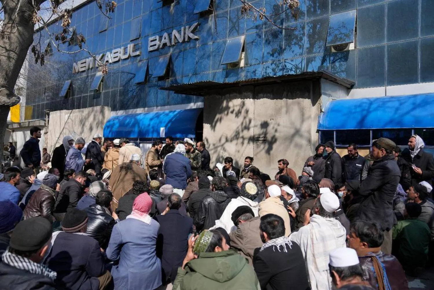 Afghan wait to enter a bank, in Kabul, Afghanistan, Sunday, Feb. 13, 2022. (AP)