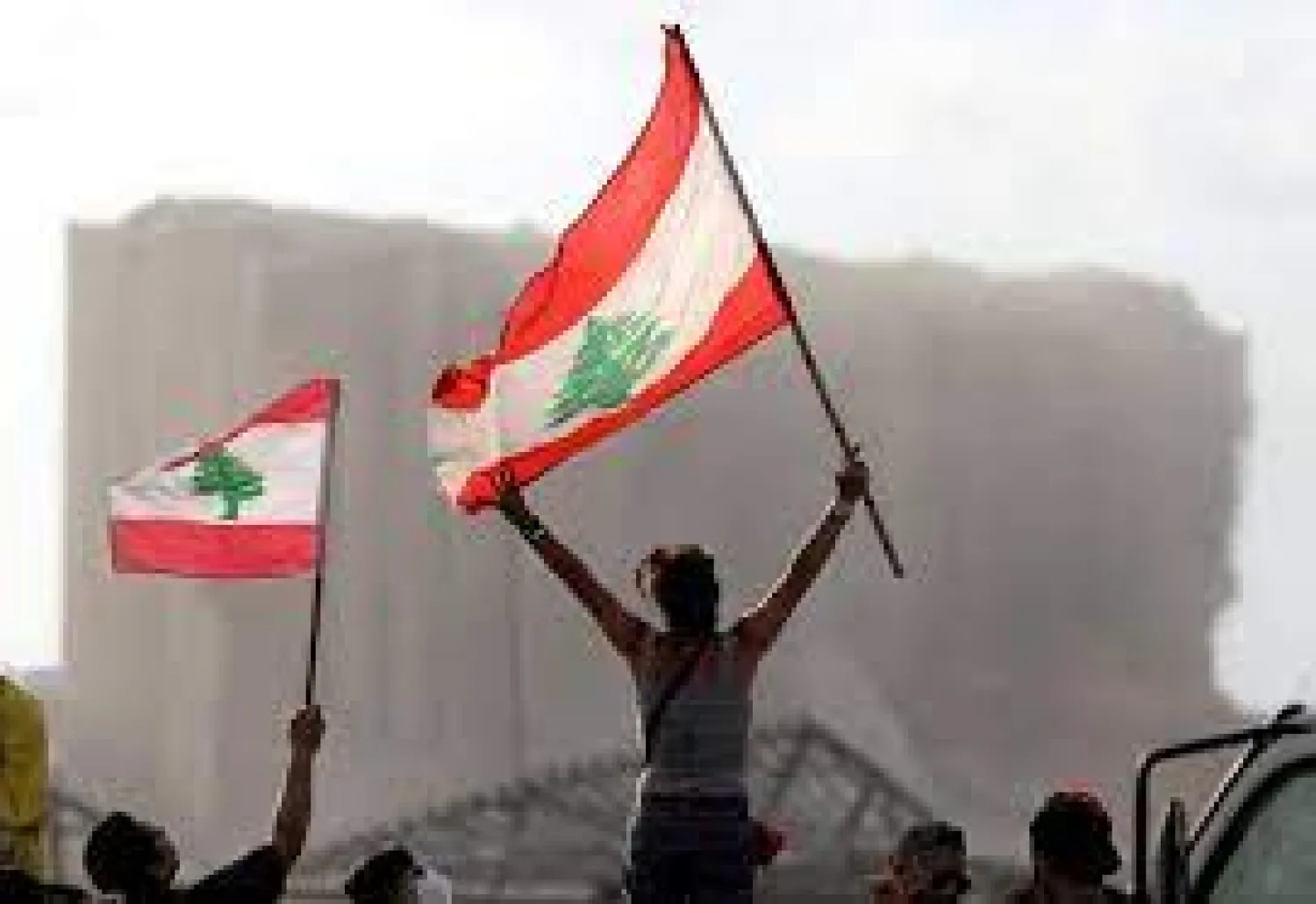 Demonstrators wave Lebanese flags during protests near the site of a blast at Beirut’s port area, Lebanon August 11, 2020. (Reuters)

 