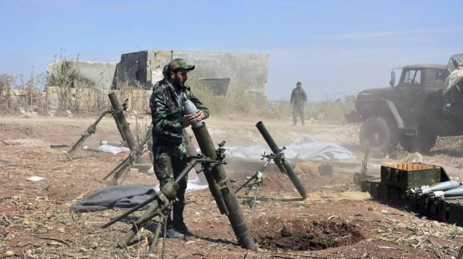 Syrian army soldiers prepare to launch a mortar towards insurgents in the village of Kfar Nabuda, in the countryside of Hama province on May 11, 2019. (SANA via AP)
