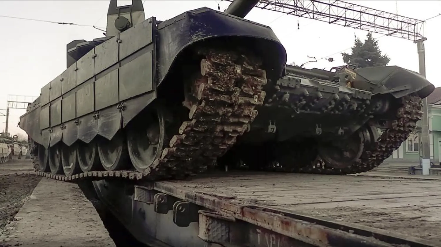 In this photo taken from video provided by the Russian Defense Ministry Press Service on Tuesday, Feb. 15, 2022, a Russian tank is loaded onto railway platforms after the end of military drills in South Russia. (Russian Defense Ministry Press Service via AP)