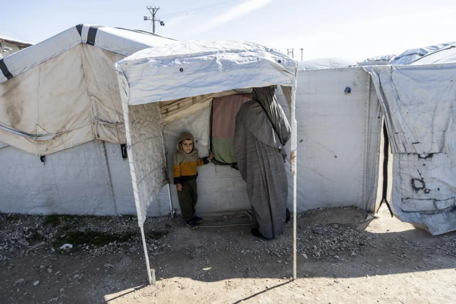 A woman and a child stand in Roj detention camp in northeast Syria Wednesday, Feb. 9, 2022. (AP Photo/Baderkhan Ahmad)
