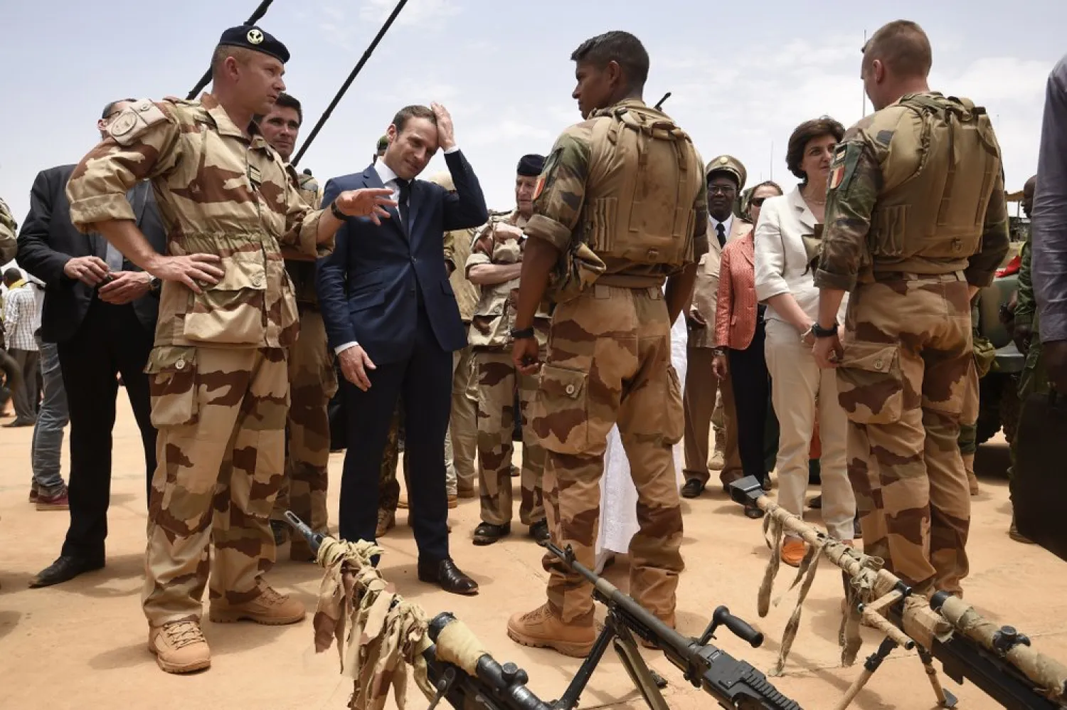 FILE - In this May 19, 2017 file photo, French President Emmanuel Macron, center left, visits soldiers of Operation Barkhane, France's largest overseas military operation, in Gao, Northern Mali. (Christophe Petit Tesson, Pool via AP)
