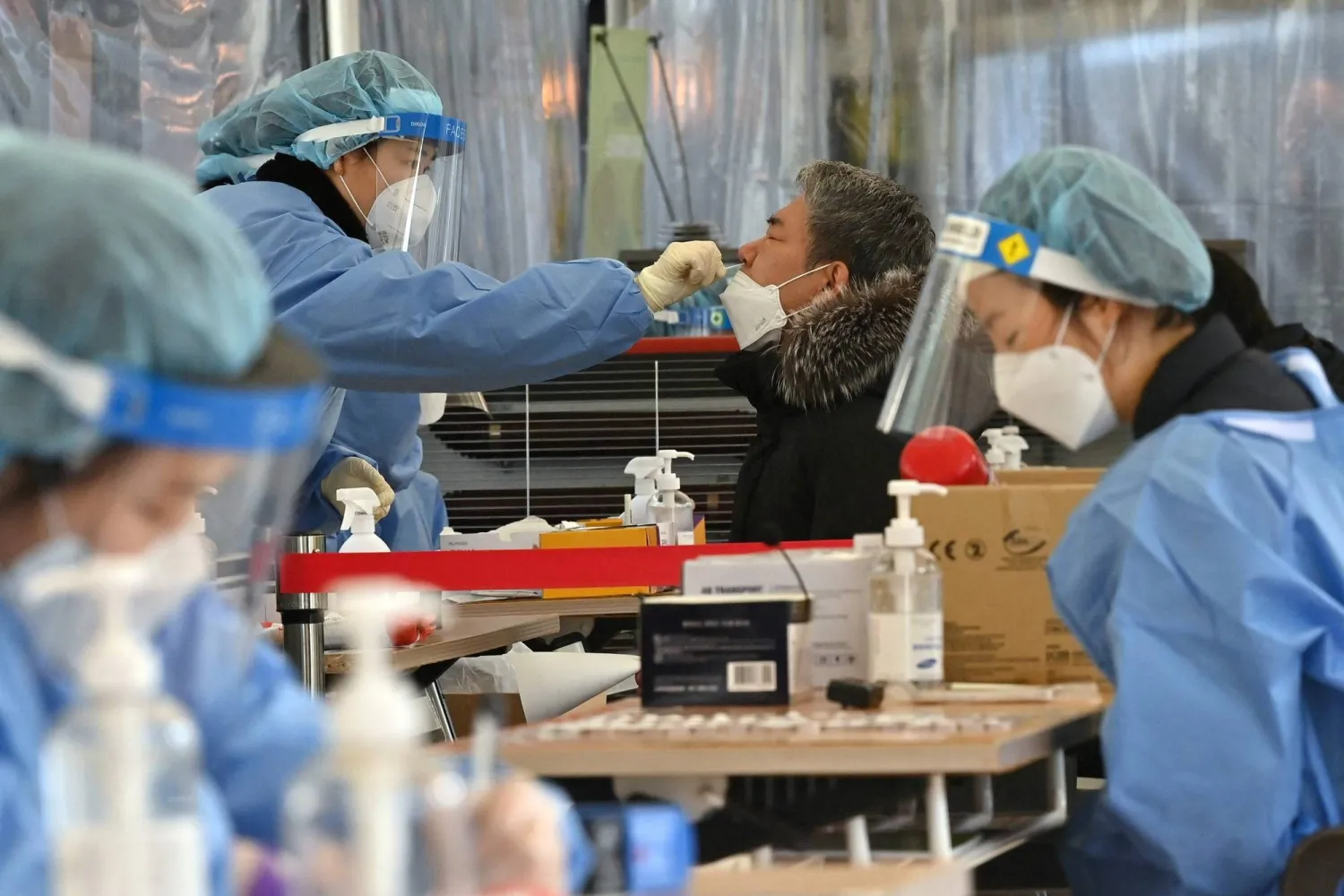 A medical staff member takes a nasal swab at a COVID-19 testing center in Seoul on Wednesday.  AFP-JIJI
