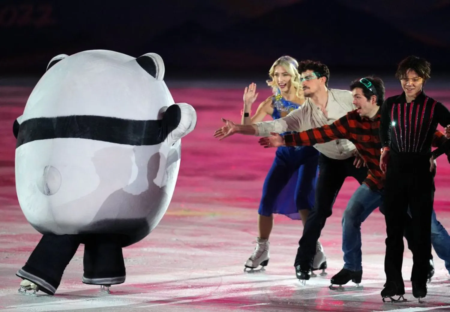 Piper Gilles of Canada and Paul Poirier of Canada, Keegan Messing of Canada and Shoma Uno of Japan with Bing Dwen Dwen, the mascot of the Beijing 2022 Winter Olympics during the exhibition gala. (Reuters)