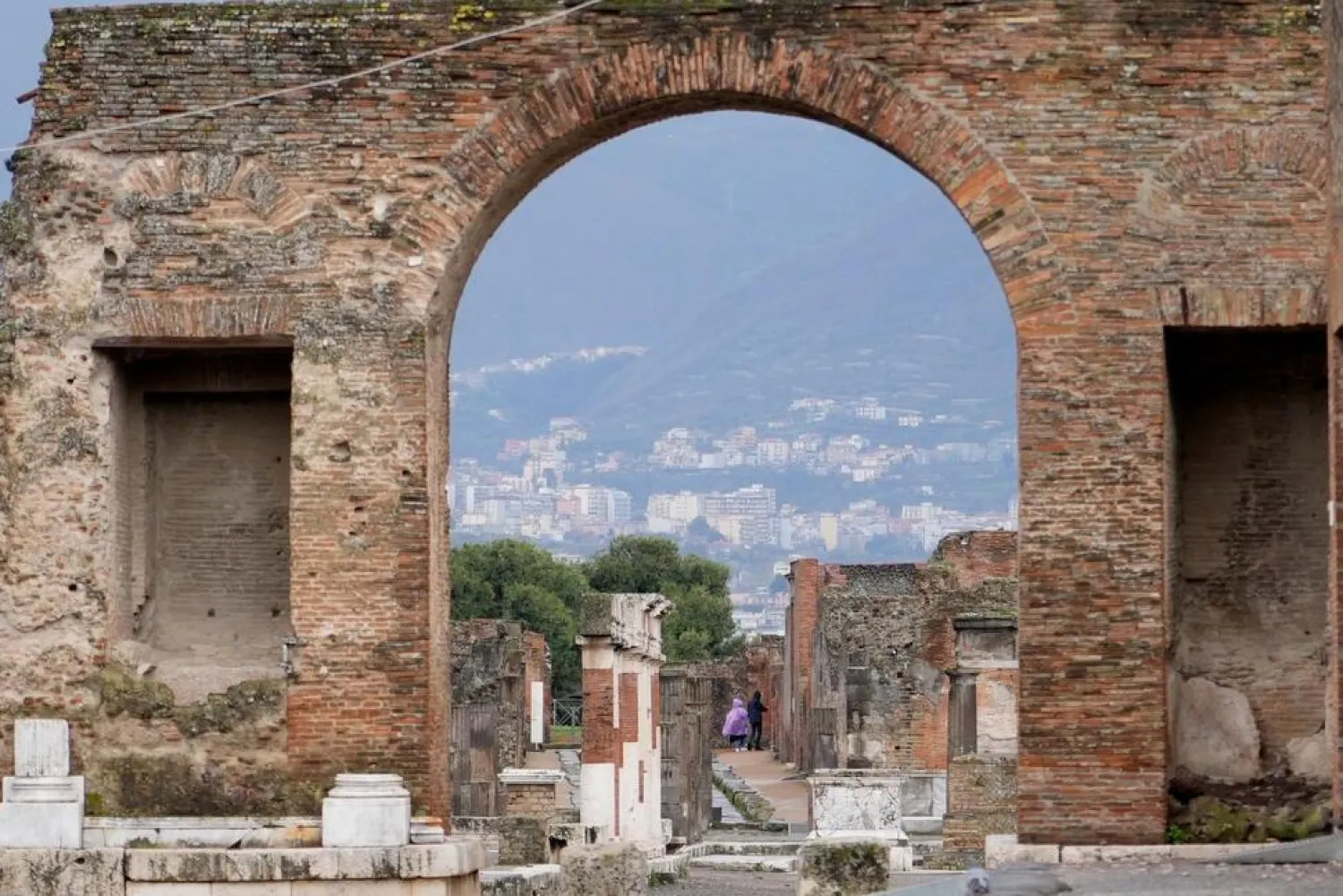 Tourists walk inside the Pompeii archaeological site in southern Italy, Tuesday, Feb. 15, 2022. (AP)