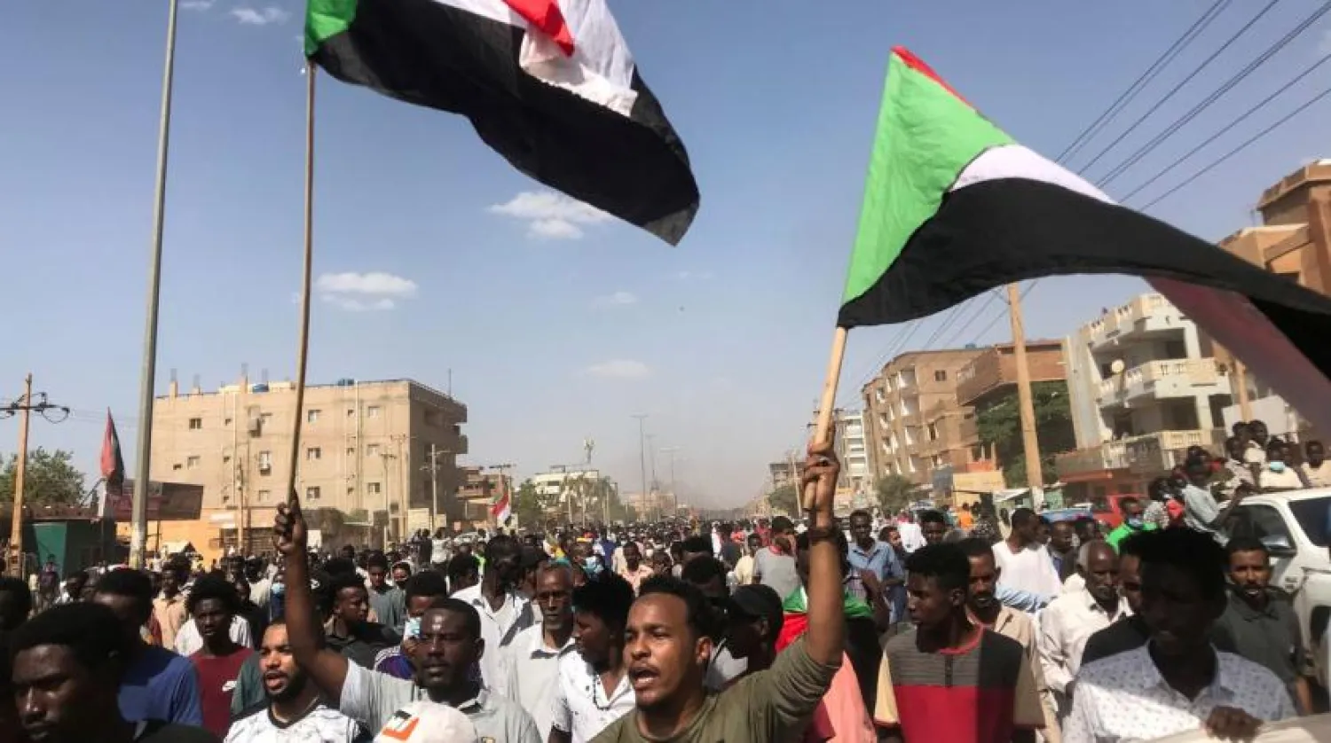 Protesters hold flags and chant slogans as they march against the Sudanese military's recent seizure of power and ousting of the civilian government, in the streets of the capital Khartoum, Sudan October 30, 2021. (Reuters) 