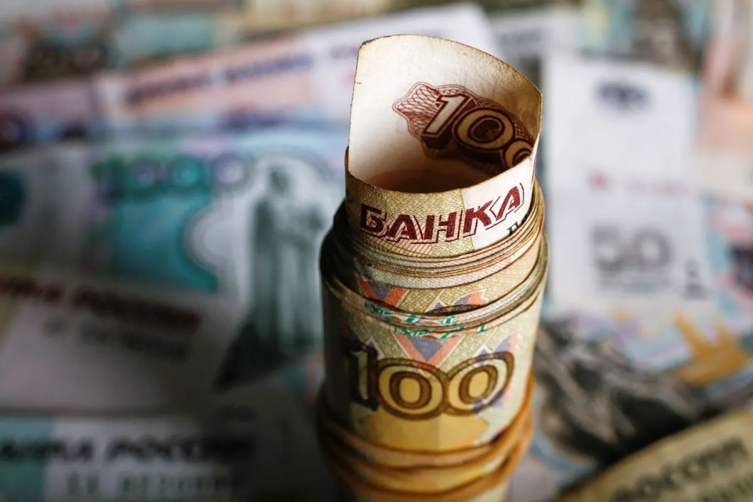 A picture illustration shows rolled Russian rouble banknotes on a table in Warsaw, Poland, January 22, 2016. (Reuters)