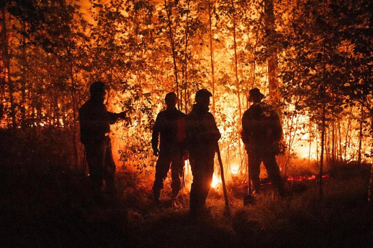 Firefighters work at the scene of forest fire near Kyuyorelyakh village at Gorny Ulus area, west of Yakutsk, in Russia Thursday, Aug. 5, 2021. (AP)