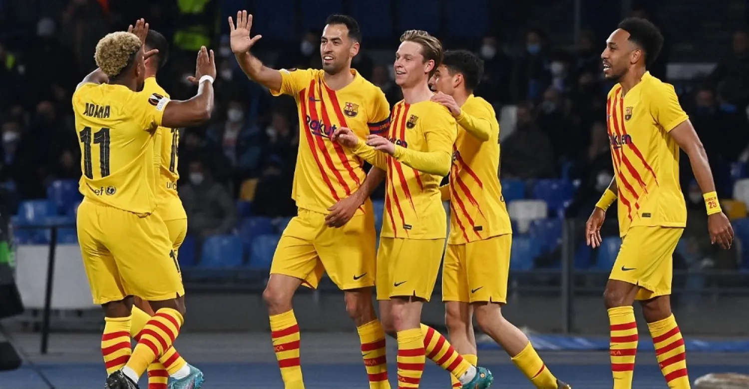 Barcelona's Dutch midfielder Frenkie De Jong (C) celebrates with teammates after scoring his team's second goal during the UEFA Europa League knockout round play-off second leg football match between SSC Napoli and FC Barcelona on February 24, 2022. (AFP)