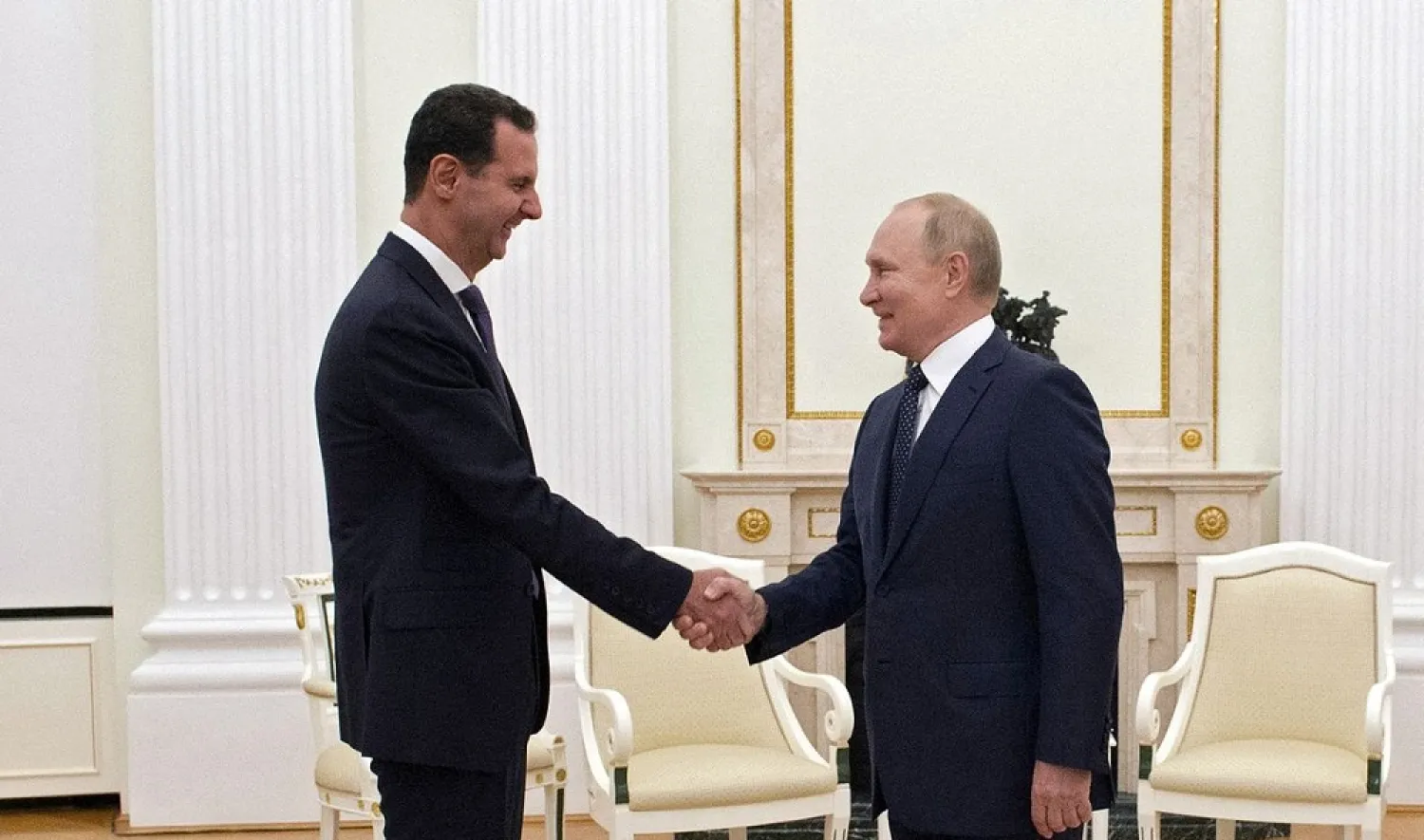 Russian President Vladimir Putin shakes hands with Syrian President Bashar al-Assad during a meeting at the Kremlin in Moscow, Russia, September 13, 2021. Picture taken September 13, 2021. (Kremlin via Reuters)