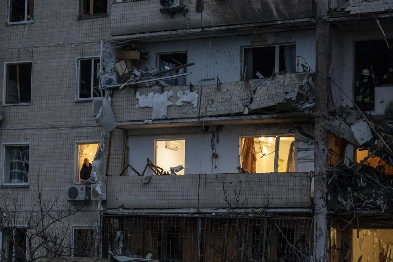 A man inspects the damage at a building following a rocket attack on the city of Kyiv, Ukraine, Friday, Feb. 25, 2022. (AP)