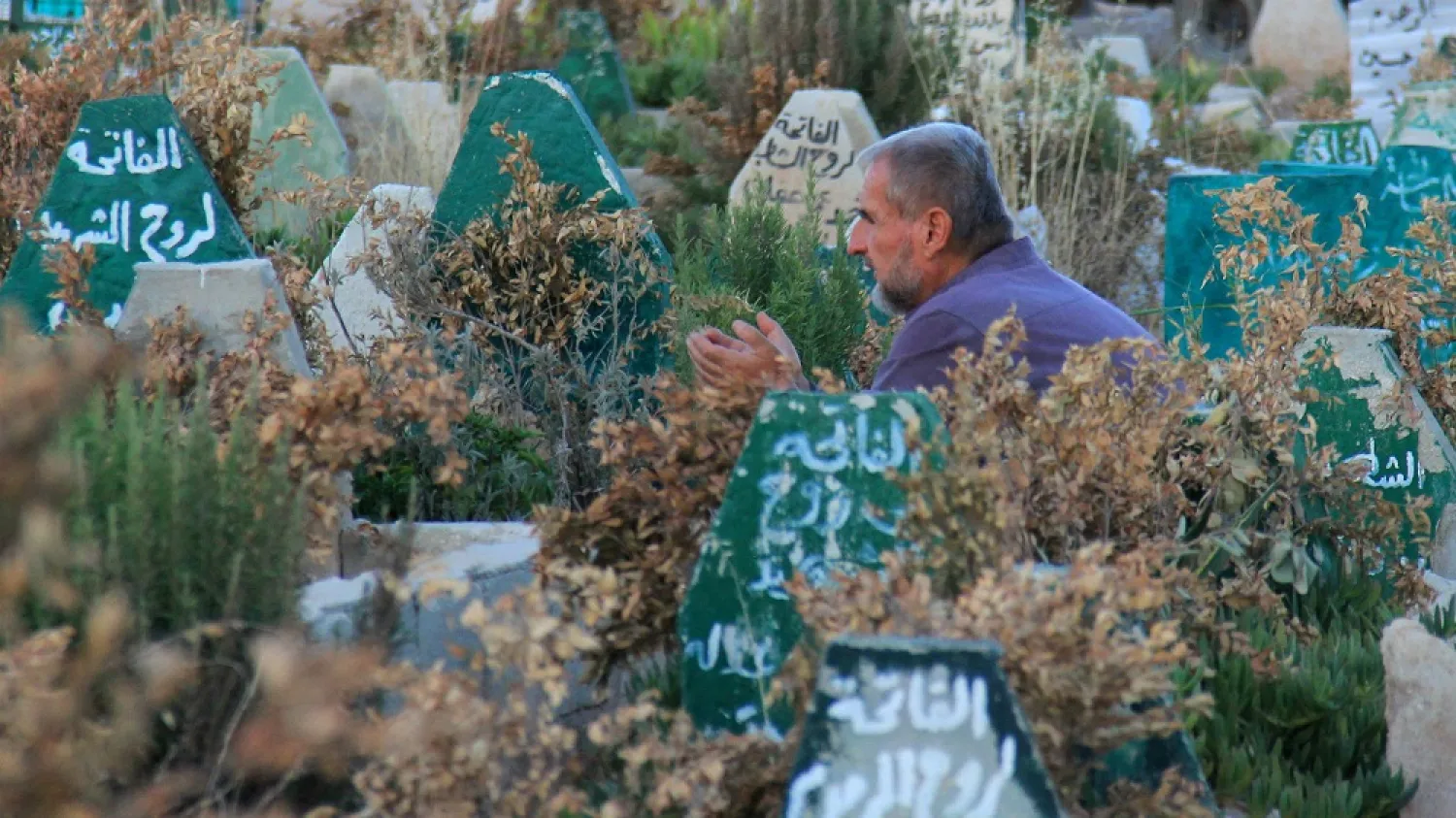 A Syrian man prays at a cemetery in Khan Sheikhun, a town in the northwestern Syrian Idlib province, 100 days following a suspected toxic gas attack that was reported to have killed 88 people, including 31 children. (AFP file photo) 