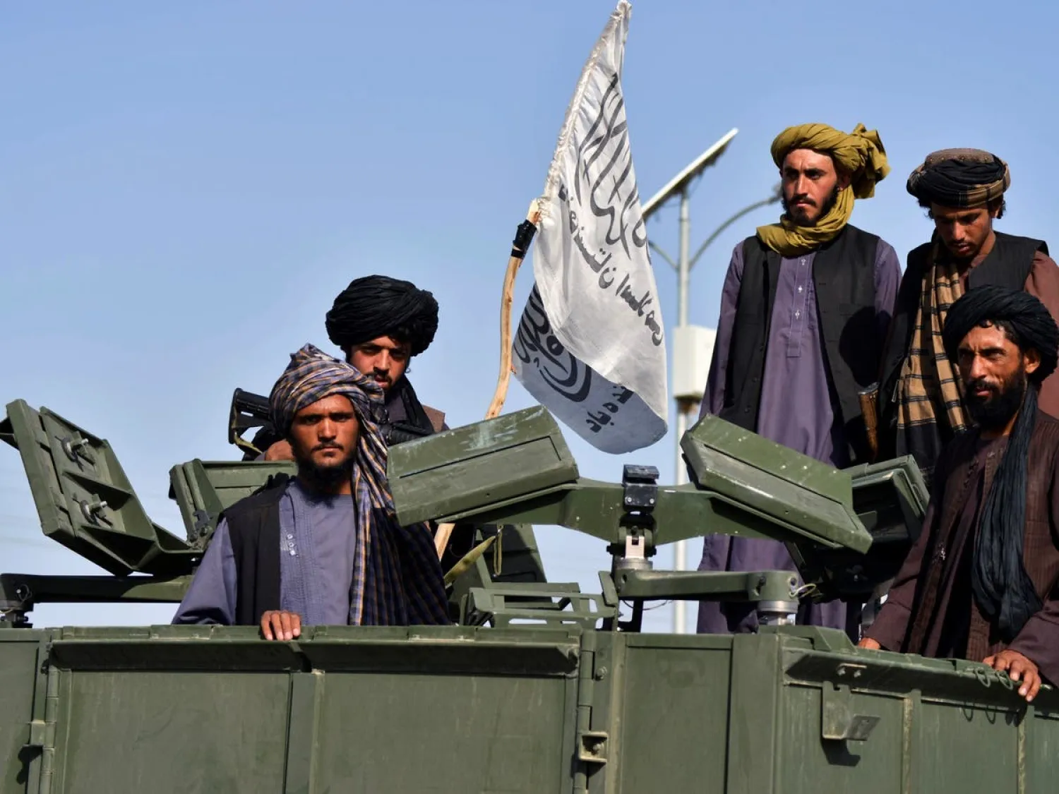 File Photo: Taliban fighters parade along a road to celebrate after the US pulled all its troops out of Afghanistan, Sept. 1, 2021. (AFP)