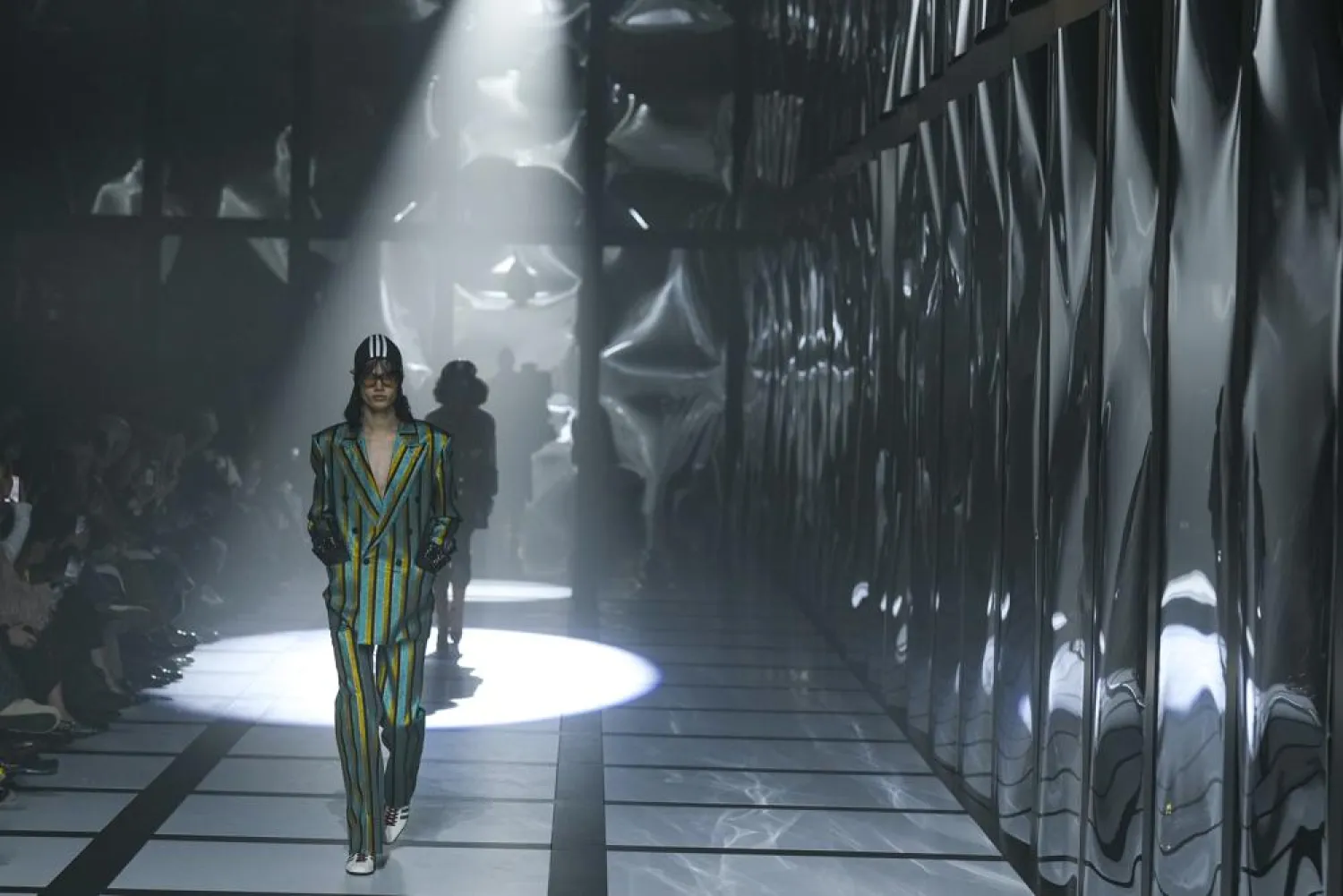 A model wears a creation as part of the Gucci Fall/Winter 2022-2023 fashion collection, unveiled during the Fashion Week in Milan, Italy, Friday, Feb. 25, 2022. (AP)