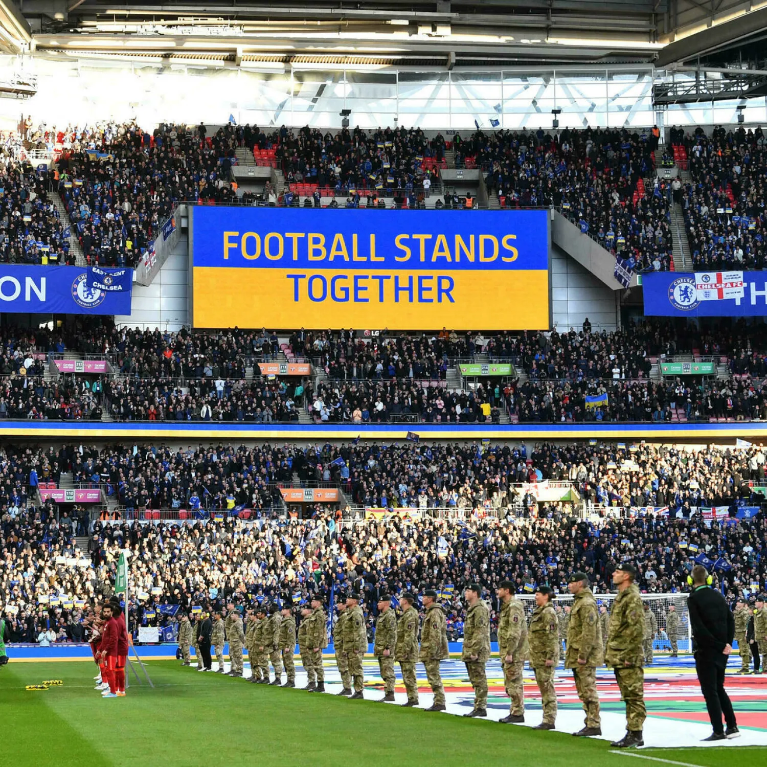 A 'Football Stands Together' message is displayed in Ukrainian colors ahead of the English League Cup final football match between Chelsea and Liverpool at Wembley Stadium. JUSTIN TALLIS AFP
