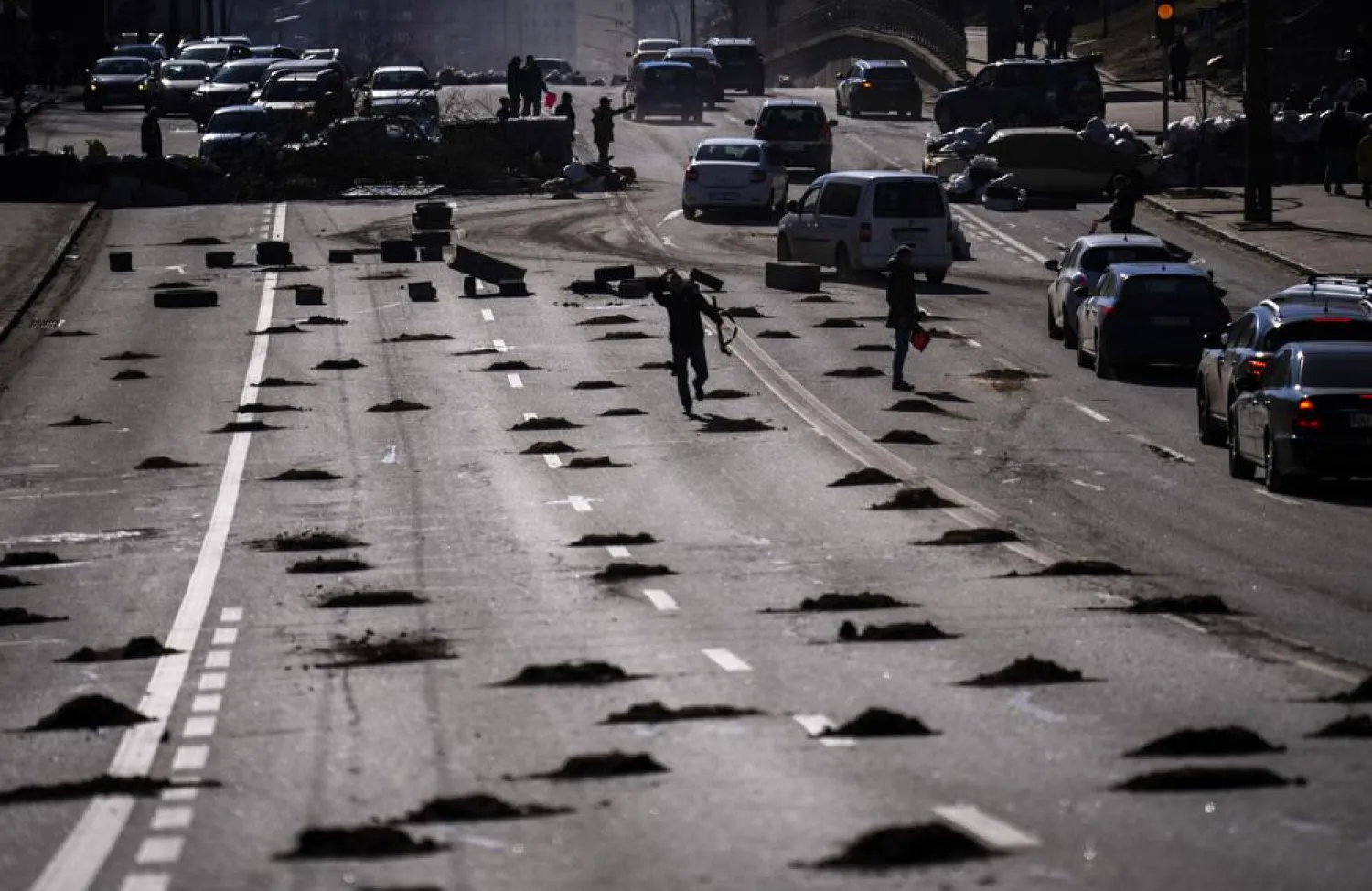 Cars are stopped at a roadblock set by civil defensemen at a road leading to central Kyiv, Ukraine, Monday, Feb. 28, 2022. (AP)