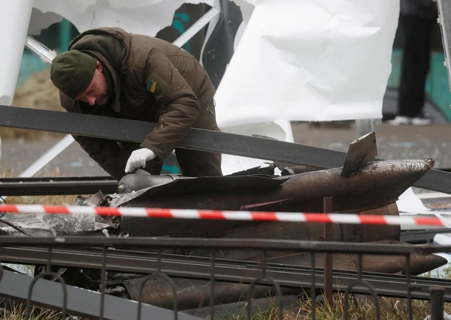 A police officer inspects the remains of a missile that landed in the street, after Russian President Vladimir Putin authorized a military operation in eastern Ukraine, in Kyiv, Ukraine February 24, 2022. (Reuters)